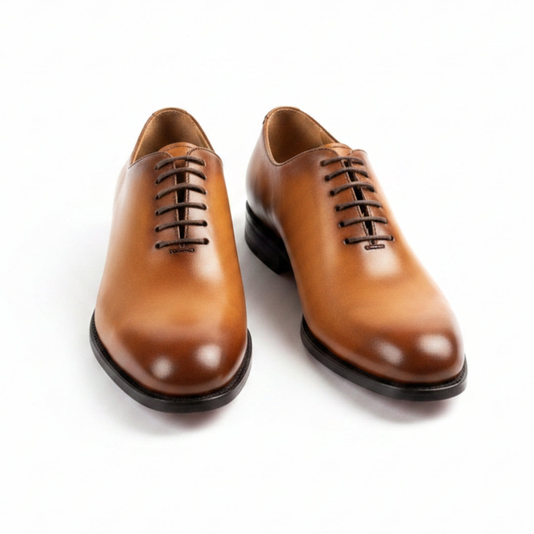 Pair of MERRIMIUM brown leather dress shoes on a white background