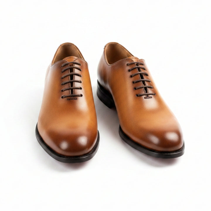 Pair of MERRIMIUM brown leather dress shoes on a white background