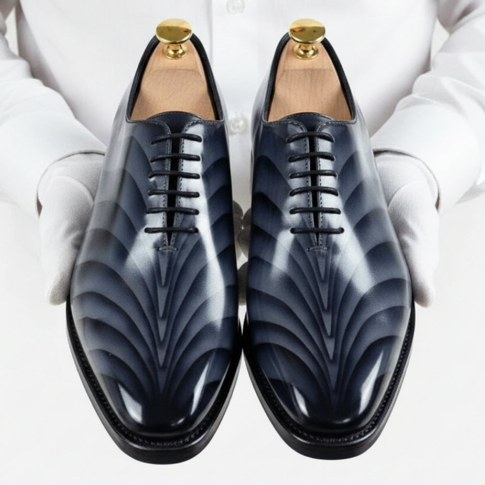 Pair of grey handmade patina dress shoes with decorative pattern by MERRIMIUM